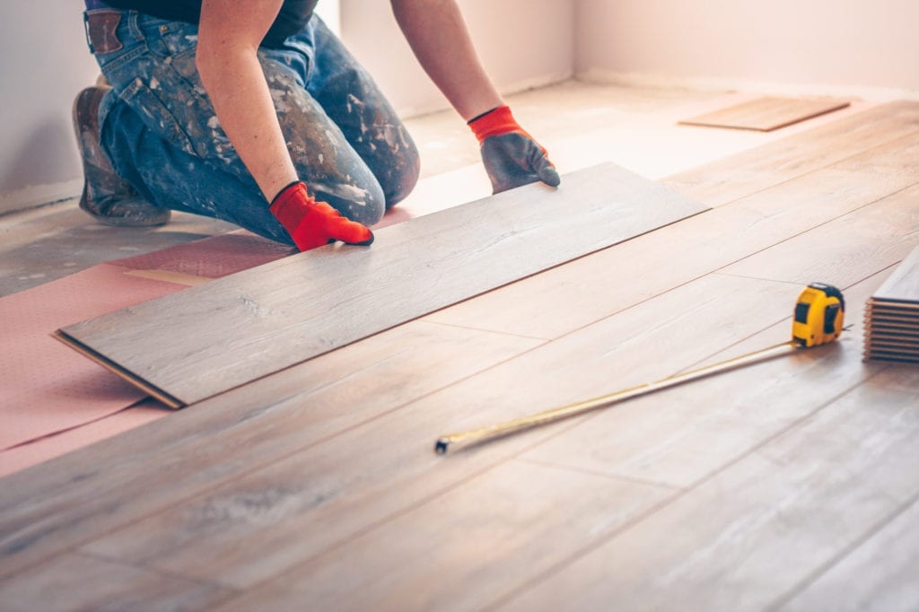 Flooring contractor professionally installs floor boards